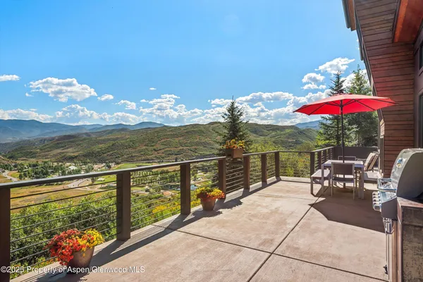 a view of a patio with couches and table and chairs and floor to ceiling window