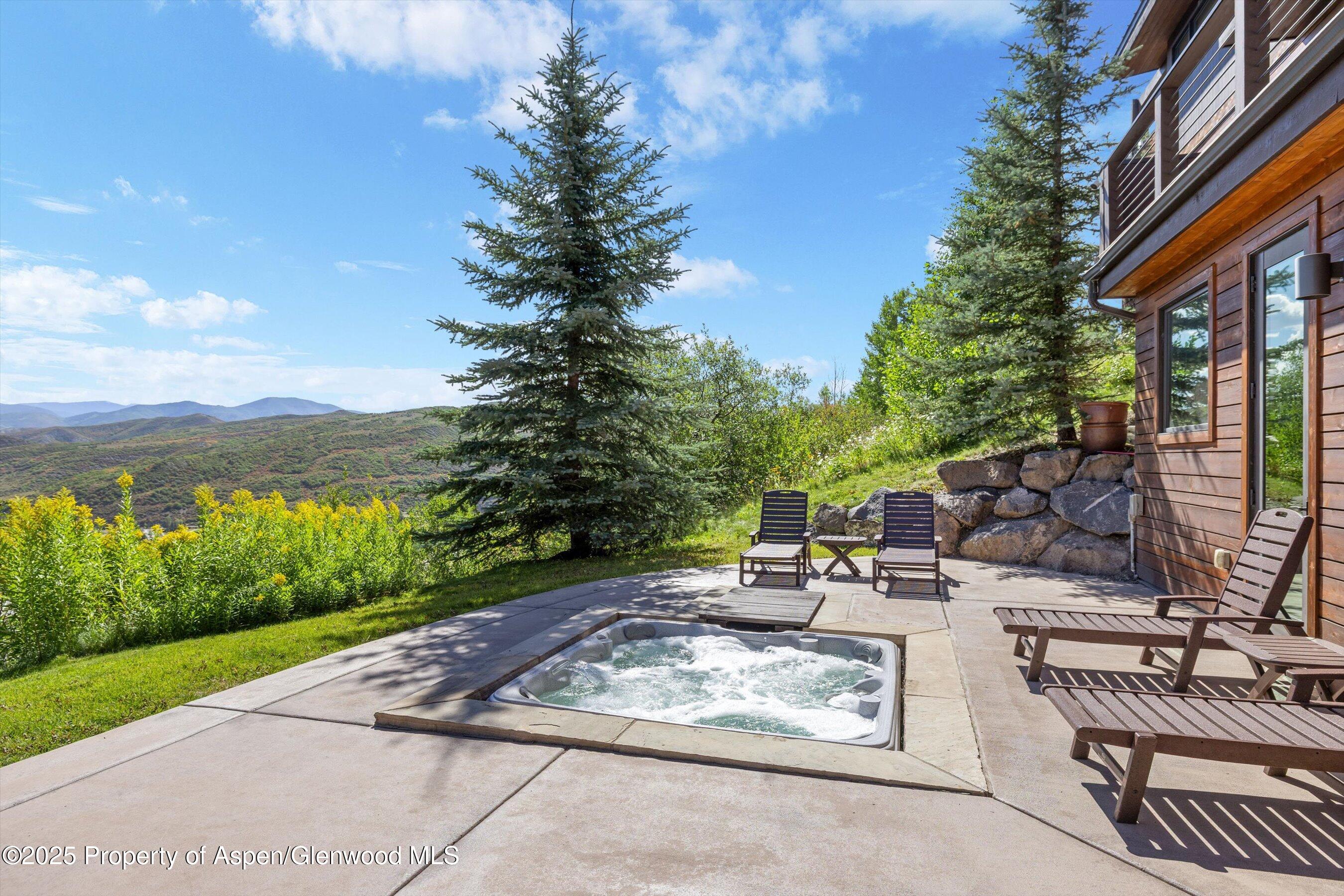 272 Oak Ridge Road Snowmass Village, CO 81615 - Photo 48 of 54 a view of a patio with couches and table and chairs and floor to ceiling window