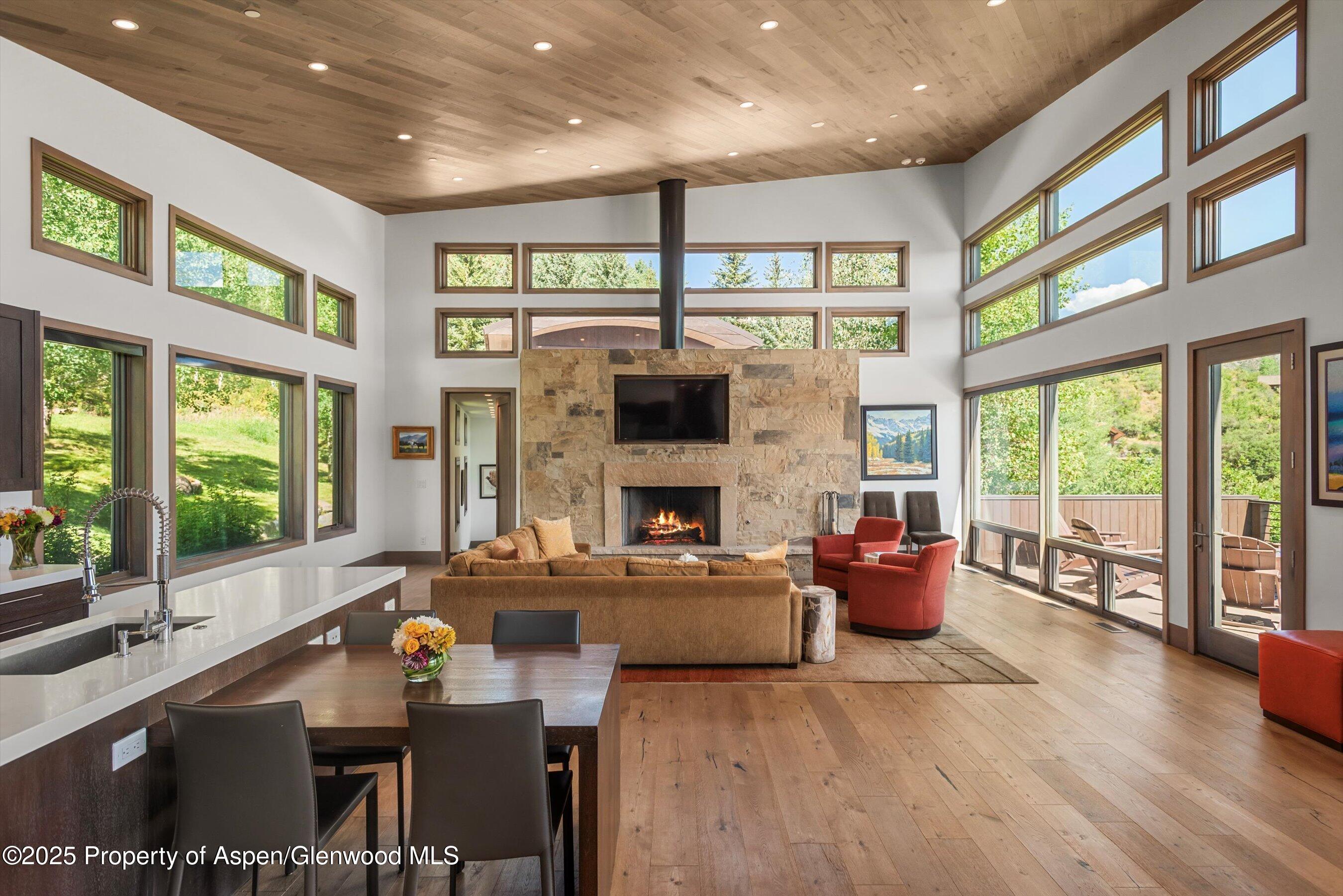 272 Oak Ridge Road Snowmass Village, CO 81615 - Photo 8 of 54 a living room with fireplace furniture and a large window