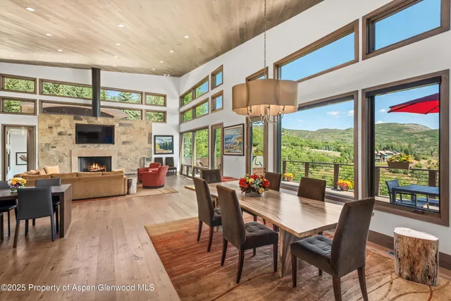 a living room with fireplace furniture and a large window
