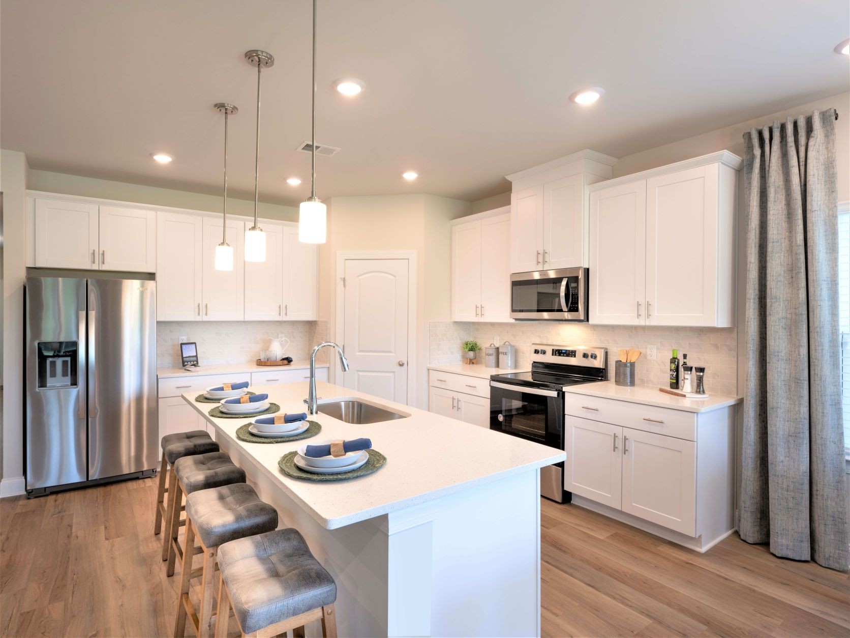723 Castle Road Mount Juliet, TN 37122 - Photo 13 of 17 a kitchen with a sink a stove a refrigerator and white cabinets with wooden floor
