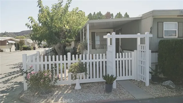 a view of a house with wooden fence