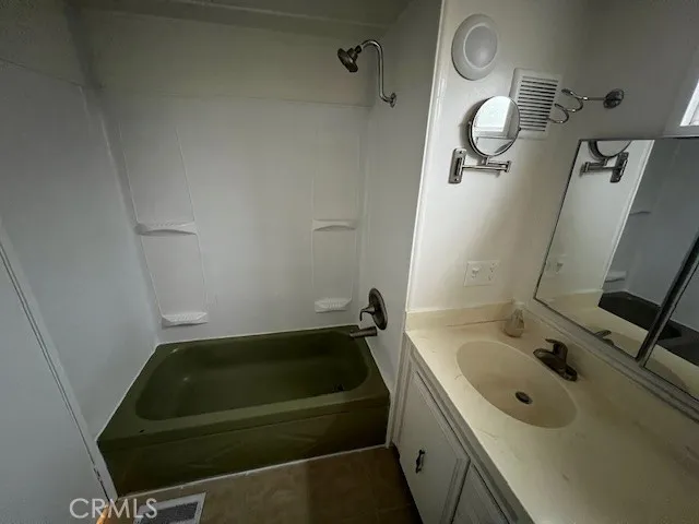 a bathroom with a sink a toilet and mirror