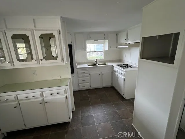 a kitchen with a stove and cabinets