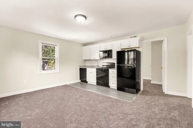 a view of a kitchen with refrigerator and microwave