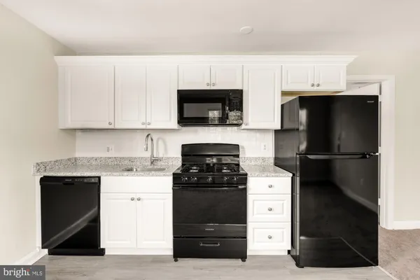 a kitchen with a stove and a refrigerator