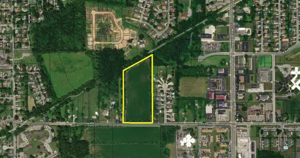 a green building with trees in front of it