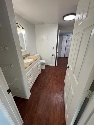 a view of a hallway view with wooden floor and staircase