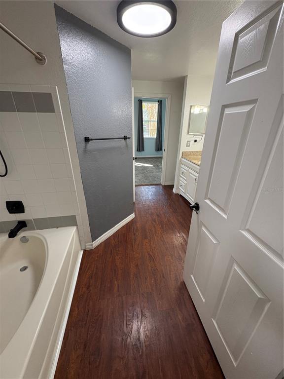 3280 Soho Street, Unit 104 Orlando, FL 32835 - Photo 15 of 23 a view of a hallway view with wooden floor and staircase