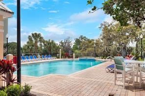 3280 Soho Street, Unit 104 Orlando, FL 32835 - Photo 20 of 23 a view of a lake with a sitting space