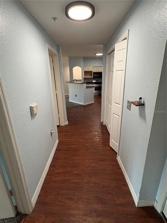 3280 Soho Street, Unit 104 Orlando, FL 32835 - Photo 3 of 23 a view of a kitchen from a hallway