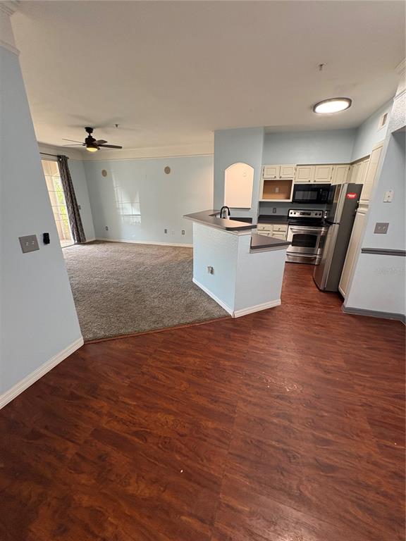 3280 Soho Street, Unit 104 Orlando, FL 32835 - Photo 7 of 23 a view of kitchen with sink microwave and stove