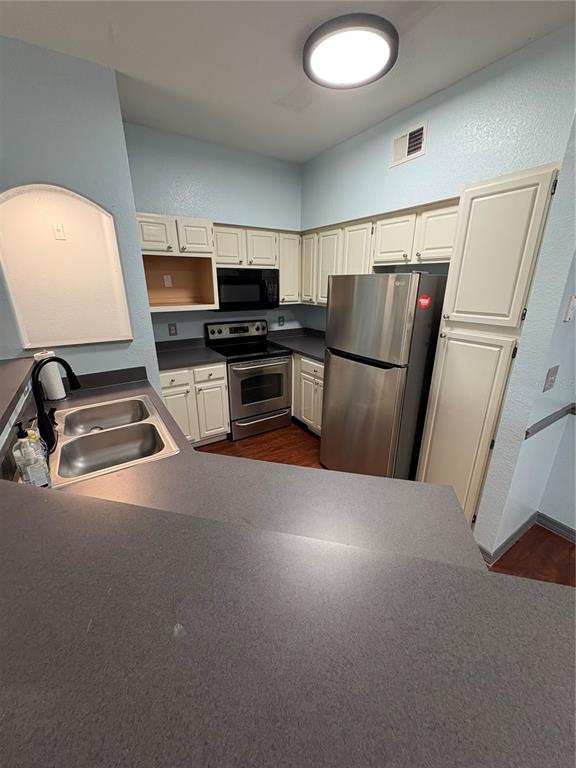 3280 Soho Street, Unit 104 Orlando, FL 32835 - Photo 8 of 23 a kitchen with a refrigerator and a sink
