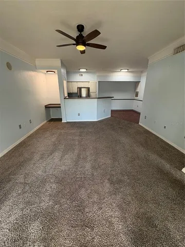 a view of a livingroom with a ceiling fan and window