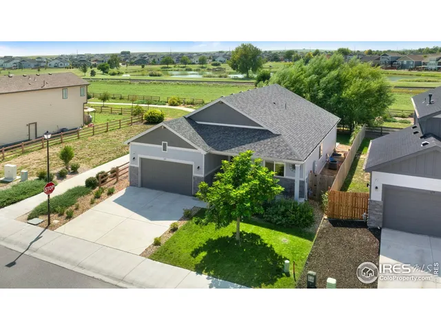 a aerial view of a house with a yard and lake view