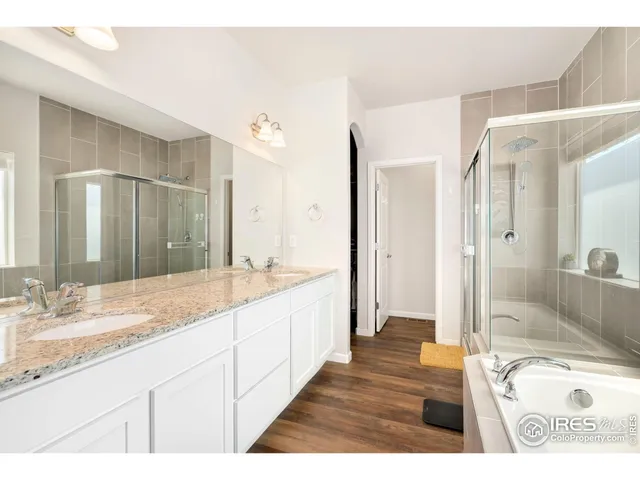 a bathroom with a granite countertop sink mirror and shower