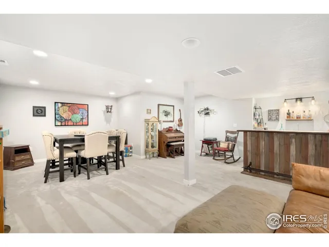 a living room with furniture and a dining table with kitchen view