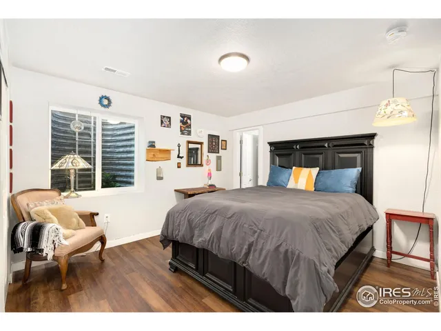 a bedroom with a large bed and a couch