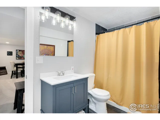 a bathroom with a toilet a sink and a mirror