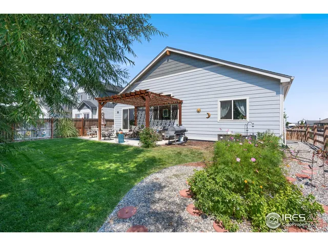 a view of a house with a yard and sitting area