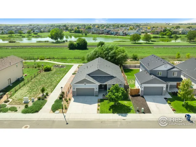 a view of a lake with a yard and potted plants