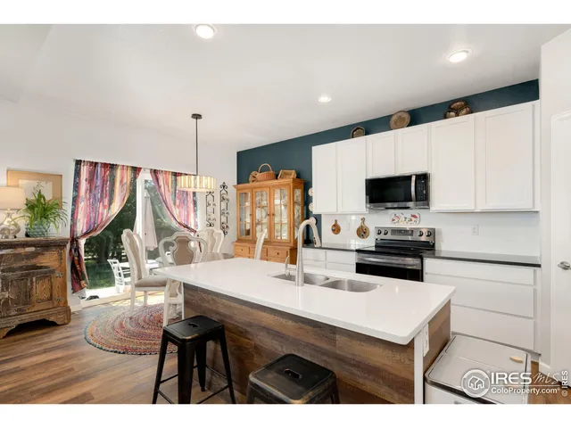 a kitchen with a table chairs stove and microwave