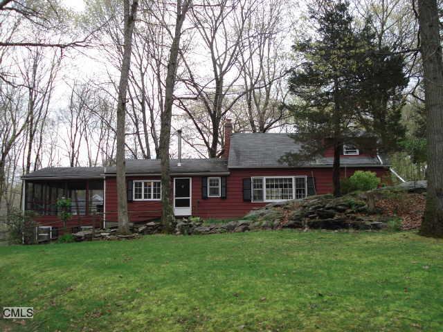 7 Powderhorn Hill Road Weston, CT 06883 - Photo 1 of 1 front view of house with a yard