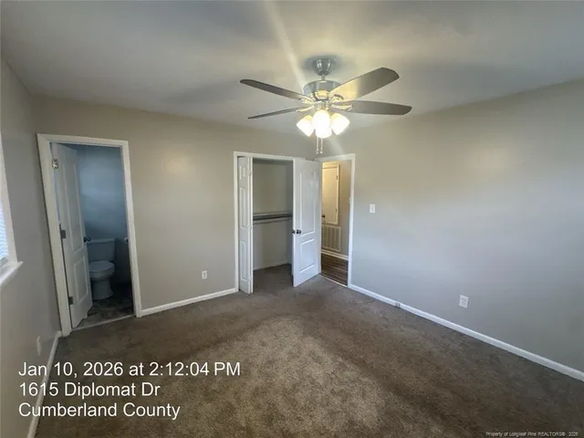 a view of a hallway with a chandelier fan