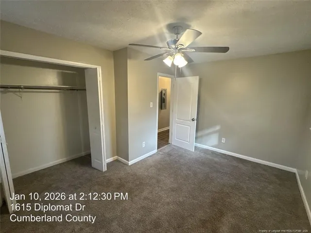 a view of a big room with a chandelier fan and closet