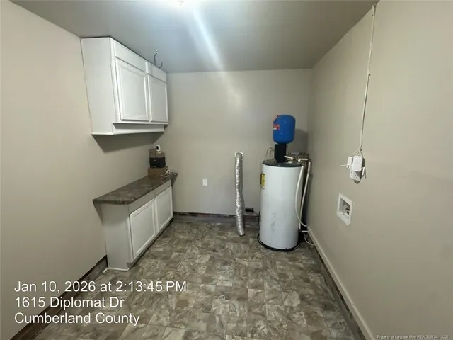 a view of storage and utility room with wooden floor