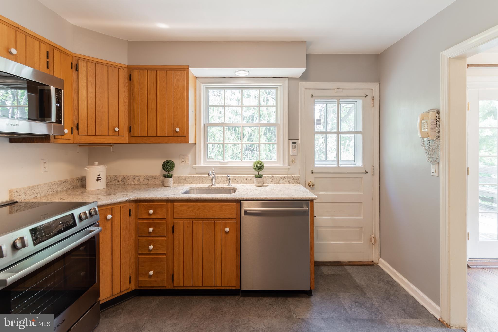 149 Clover Hill Lane Wayne, PA 19087 - Photo 19 of 50 a kitchen with stainless steel appliances granite countertop a sink stove and microwave