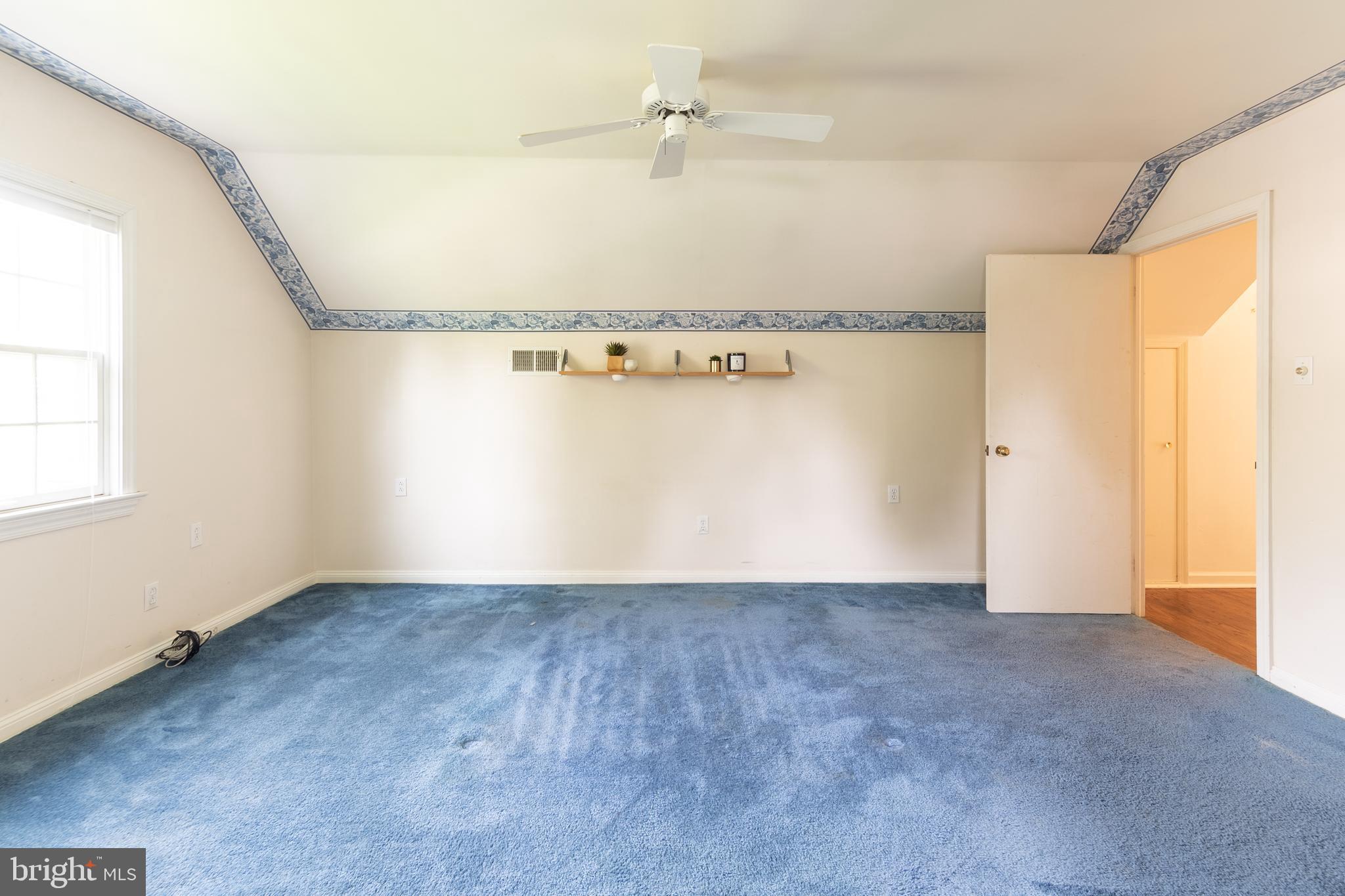 149 Clover Hill Lane Wayne, PA 19087 - Photo 39 of 50 an empty room with a window and a ceiling fan