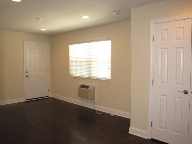 805 Piedmont Avenue Northeast, Unit 4 Atlanta, GA 30308 - Photo 3 of 9 an empty room with wooden floor and windows