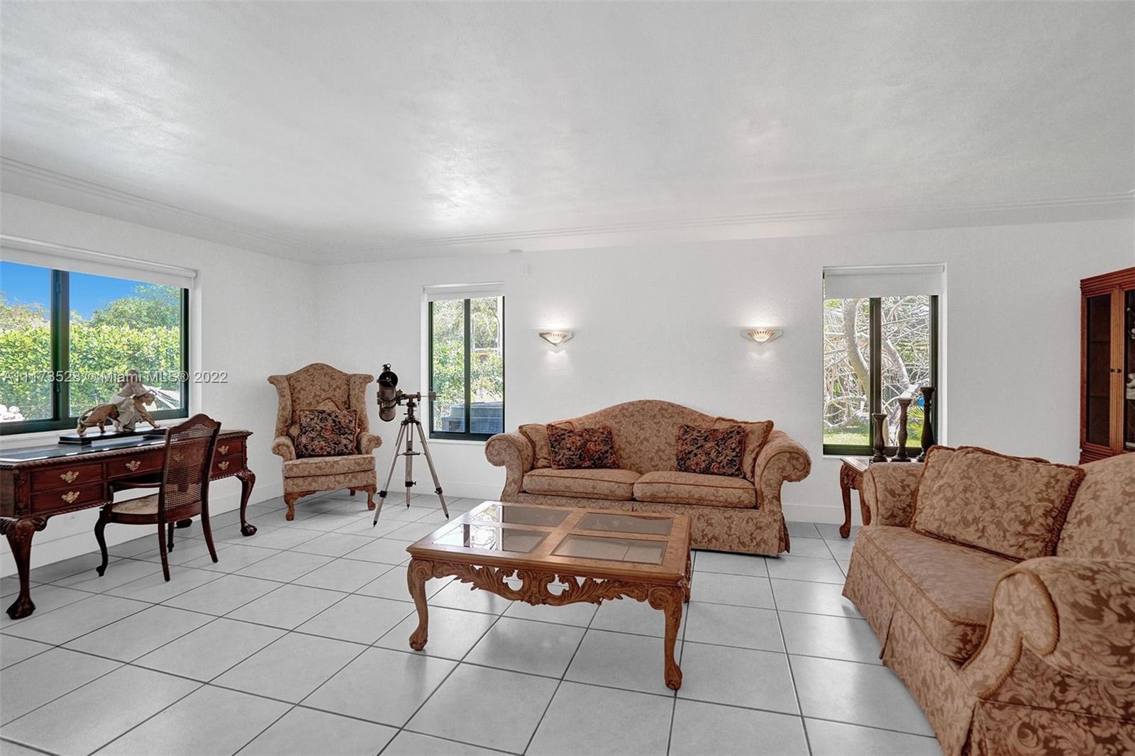 10801 Griffing Boulevard Biscayne Park, FL 33161 - Photo 13 of 77 a living room with furniture and a large window