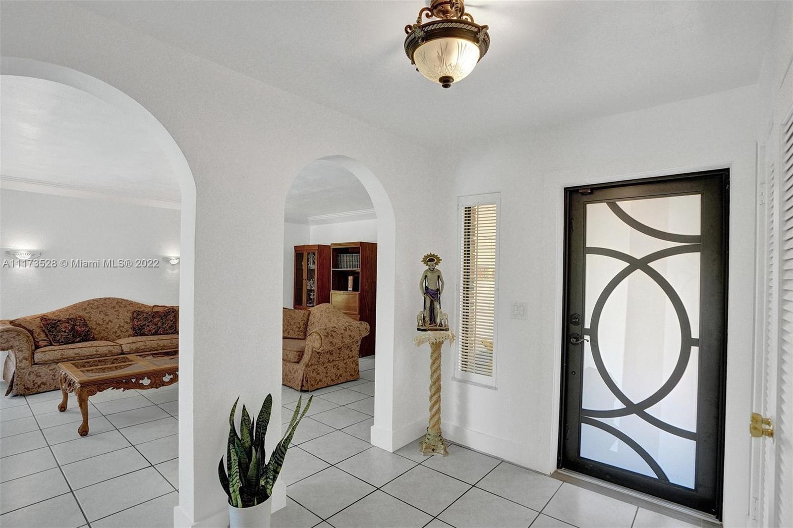 10801 Griffing Boulevard Biscayne Park, FL 33161 - Photo 16 of 77 a view of a livingroom with furniture and mirror