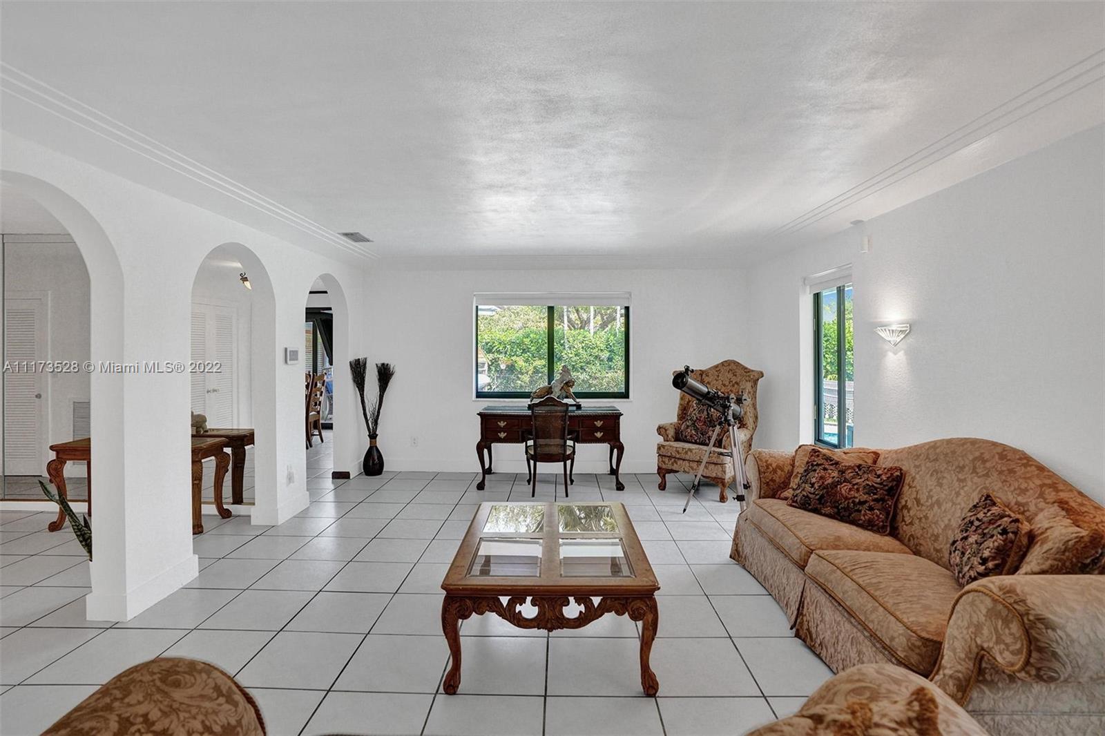 10801 Griffing Boulevard Biscayne Park, FL 33161 - Photo 19 of 77 a living room with furniture and a large window