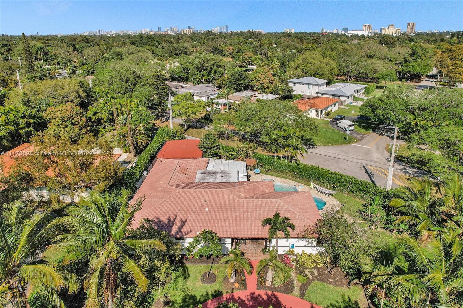10801 Griffing Boulevard Biscayne Park, FL 33161 - Photo 2 of 77 an aerial view of a house with a garden