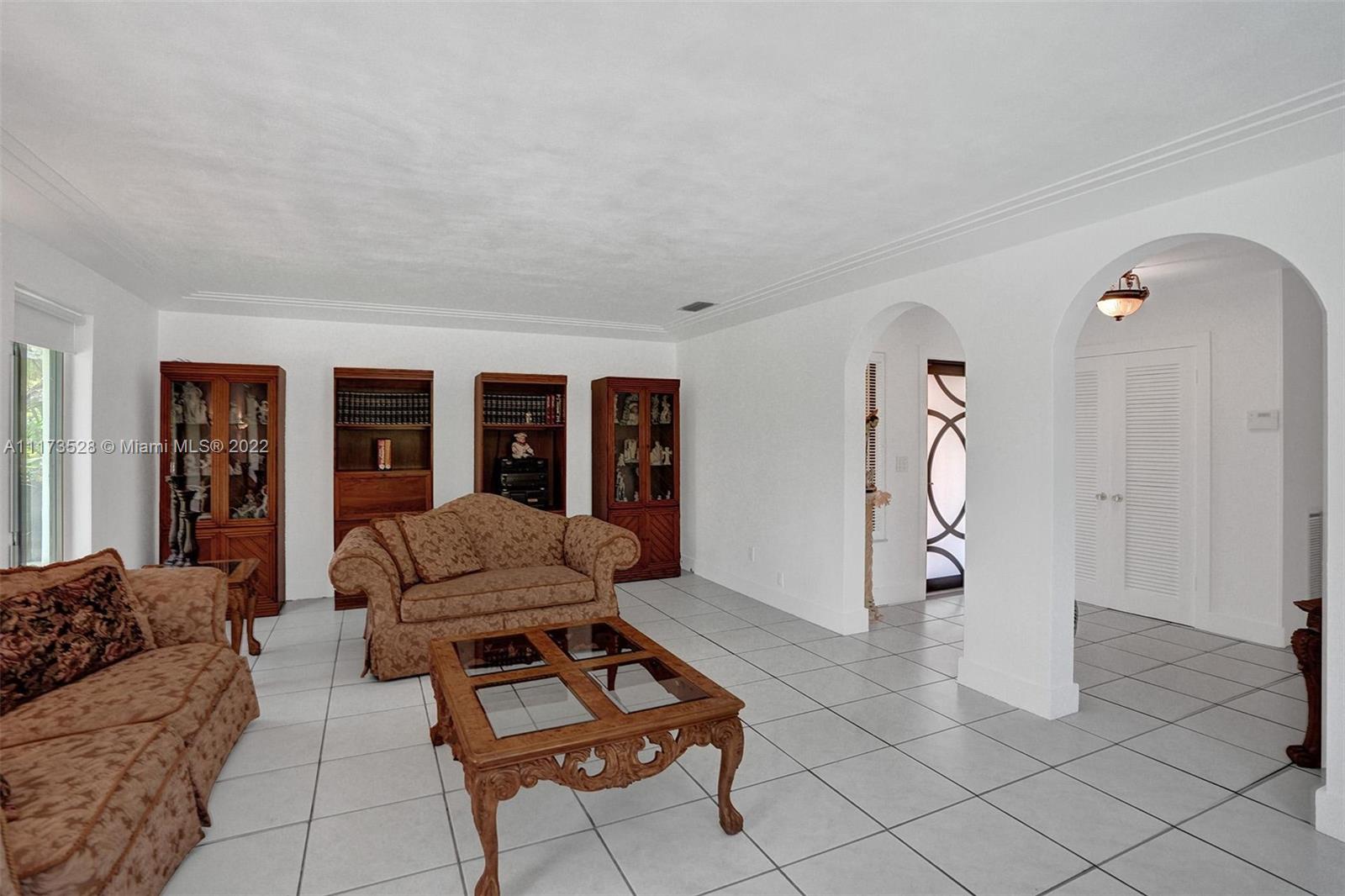 10801 Griffing Boulevard Biscayne Park, FL 33161 - Photo 21 of 77 a living room with furniture and a window