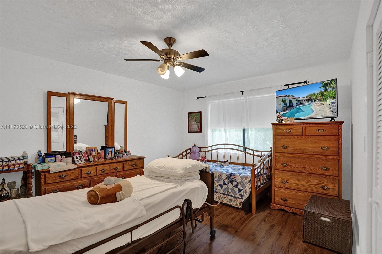 10801 Griffing Boulevard Biscayne Park, FL 33161 - Photo 22 of 77 a bedroom with furniture and a large window