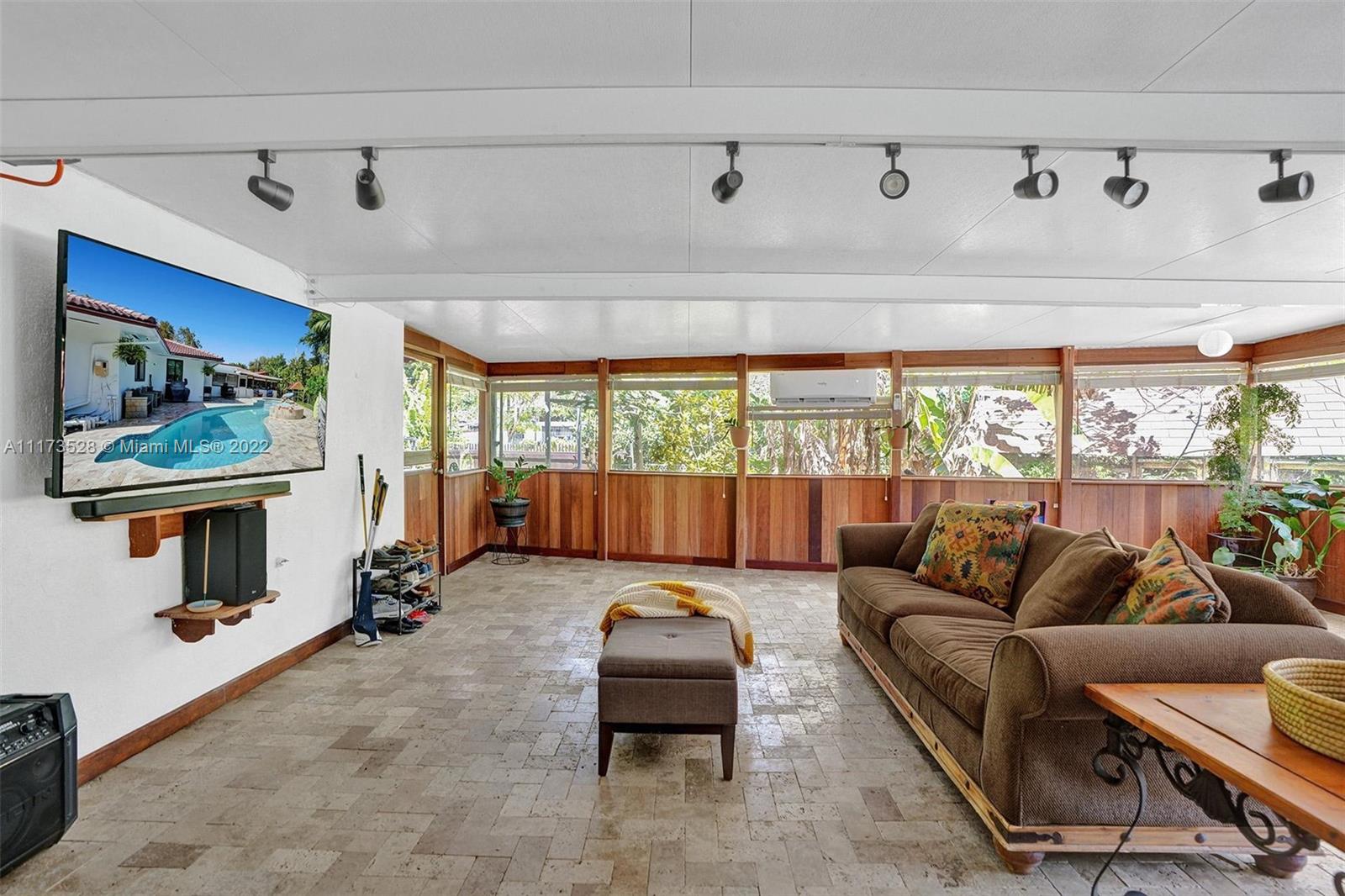 10801 Griffing Boulevard Biscayne Park, FL 33161 - Photo 32 of 77 a living room with furniture and a large window