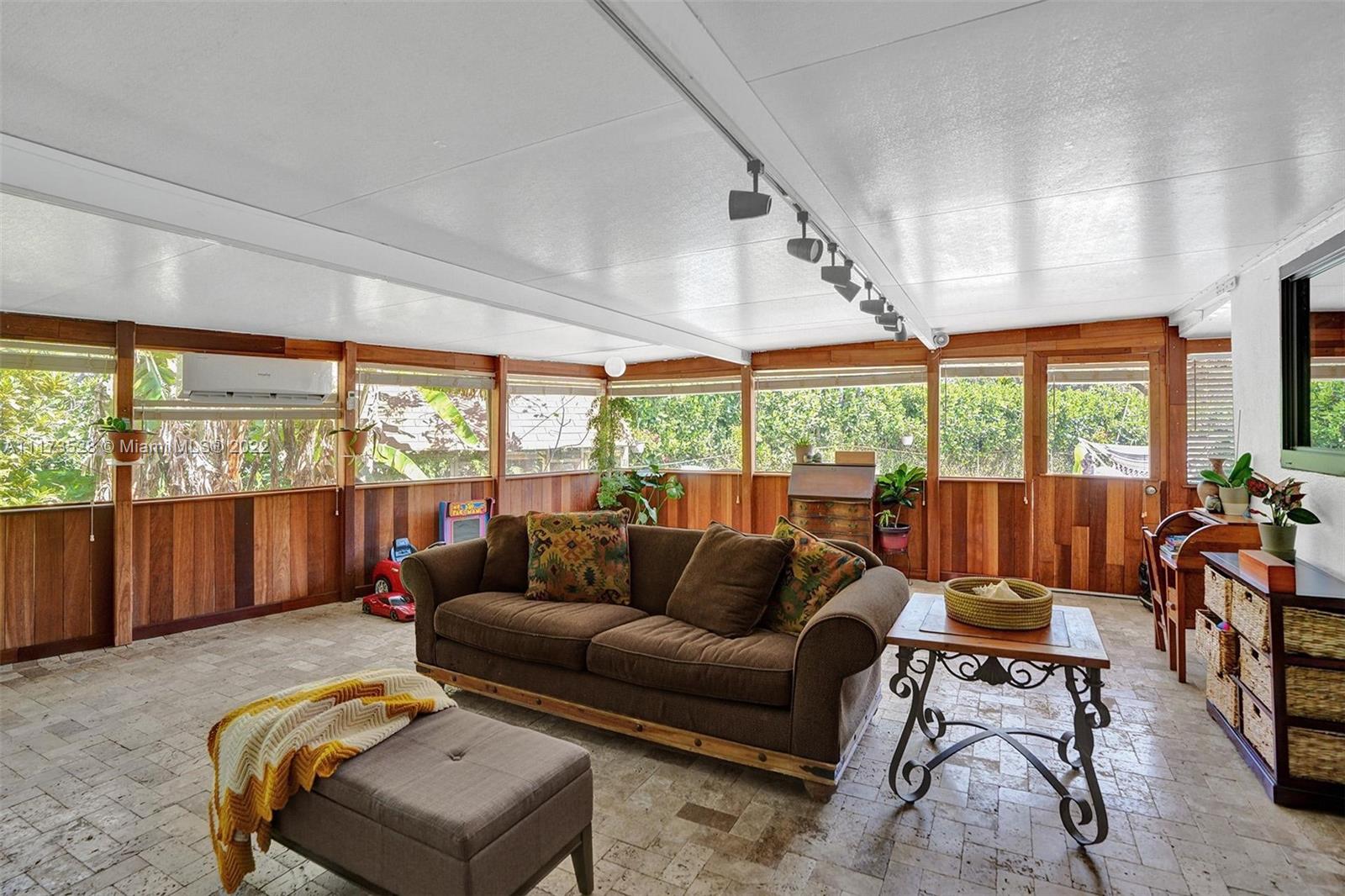 10801 Griffing Boulevard Biscayne Park, FL 33161 - Photo 33 of 77 a living room with furniture and a large window