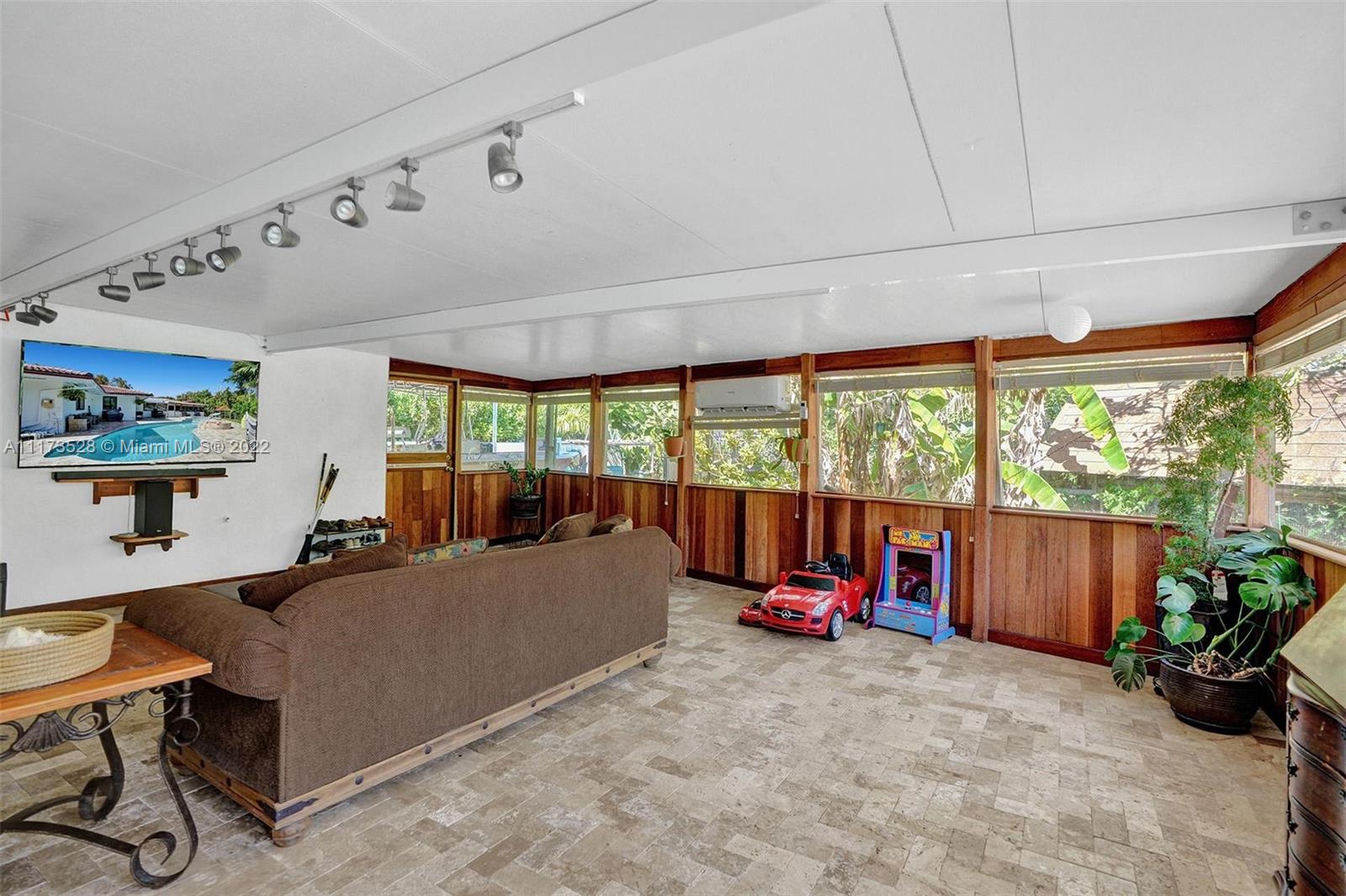 10801 Griffing Boulevard Biscayne Park, FL 33161 - Photo 34 of 77 a bed room with furniture and a large window