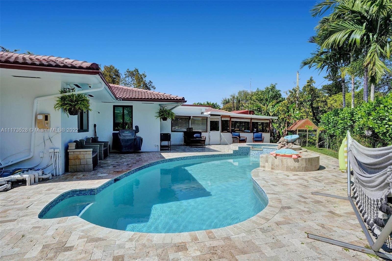 10801 Griffing Boulevard Biscayne Park, FL 33161 - Photo 37 of 77 a view of a house with swimming pool and furniture