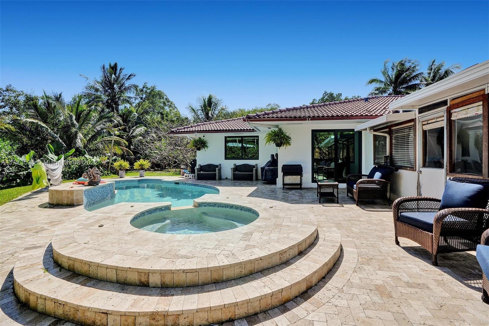 10801 Griffing Boulevard Biscayne Park, FL 33161 - Photo 39 of 77 a view of a house with swimming pool and furniture