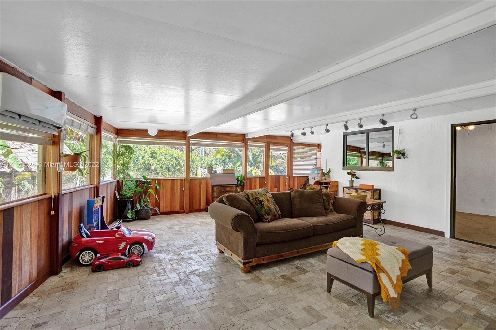 10801 Griffing Boulevard Biscayne Park, FL 33161 - Photo 40 of 77 a living room with furniture and a large window