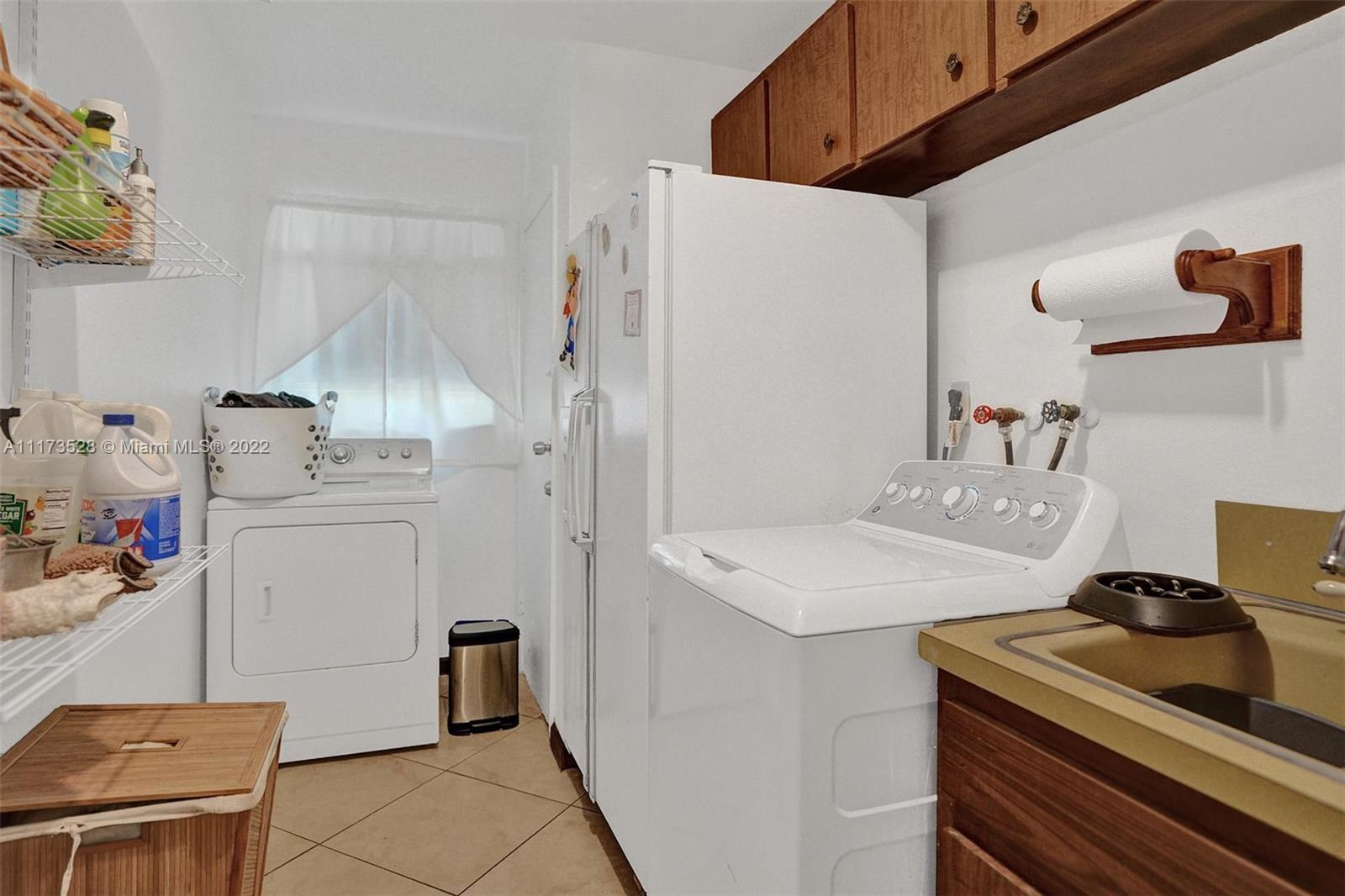 10801 Griffing Boulevard Biscayne Park, FL 33161 - Photo 54 of 77 a utility room with cabinets washer and dryer