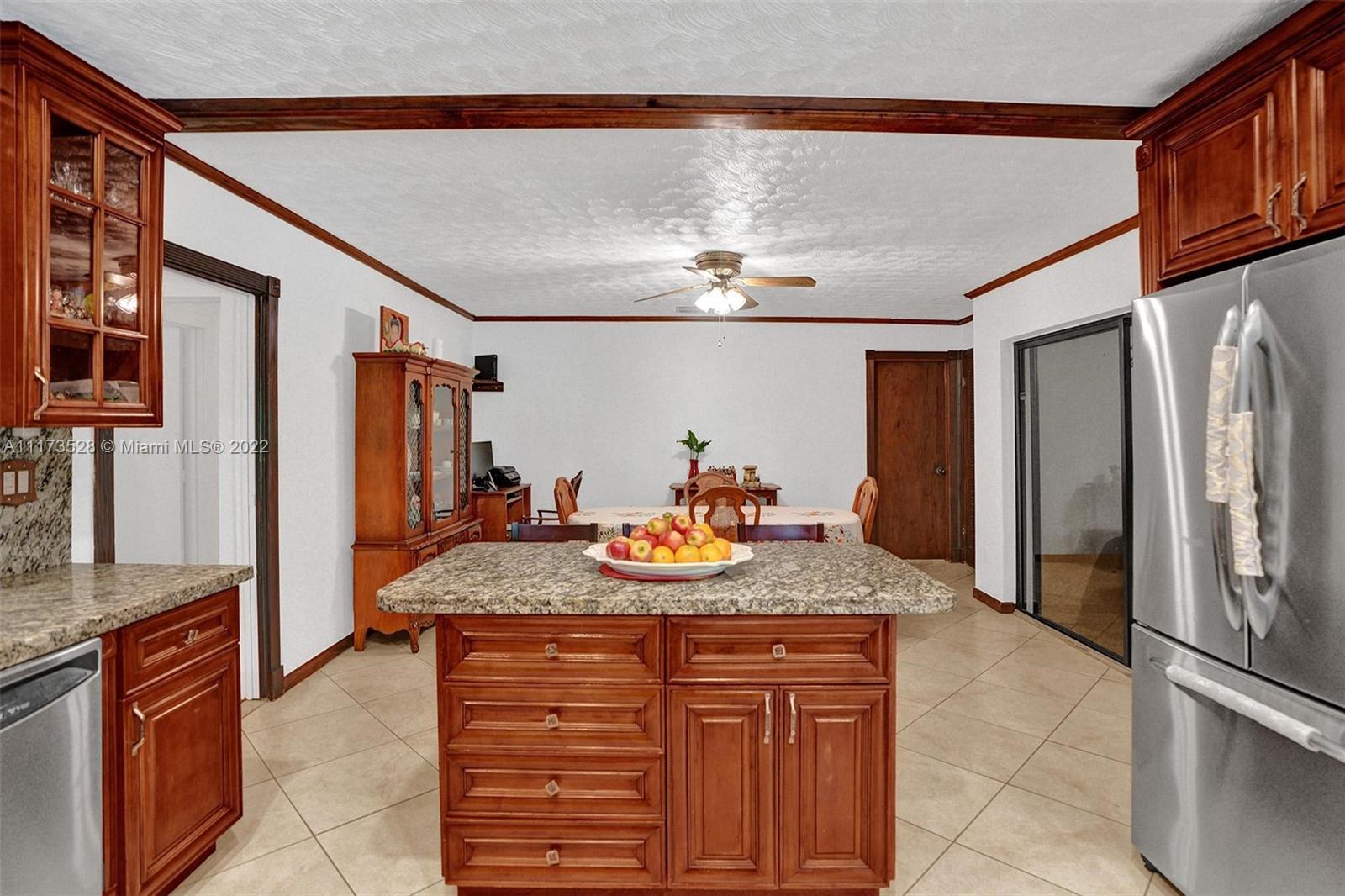 10801 Griffing Boulevard Biscayne Park, FL 33161 - Photo 65 of 77 a kitchen with stainless steel appliances granite countertop a sink and cabinets