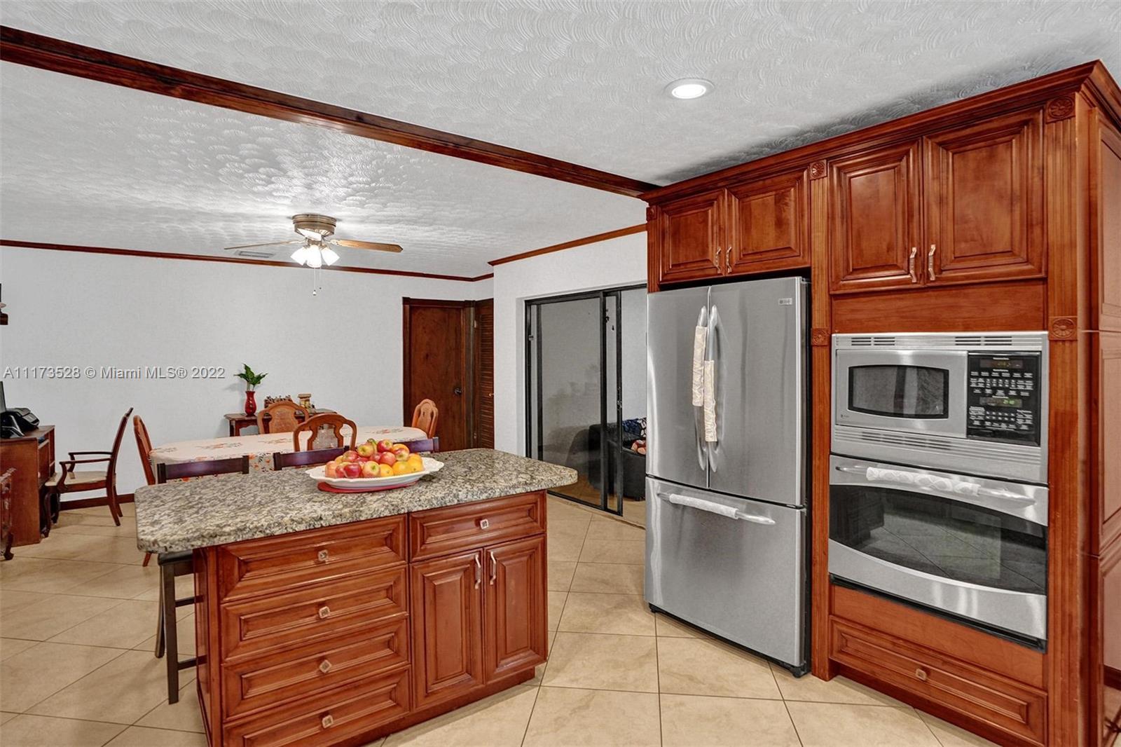 10801 Griffing Boulevard Biscayne Park, FL 33161 - Photo 67 of 77 a kitchen with stainless steel appliances granite countertop a refrigerator and a stove