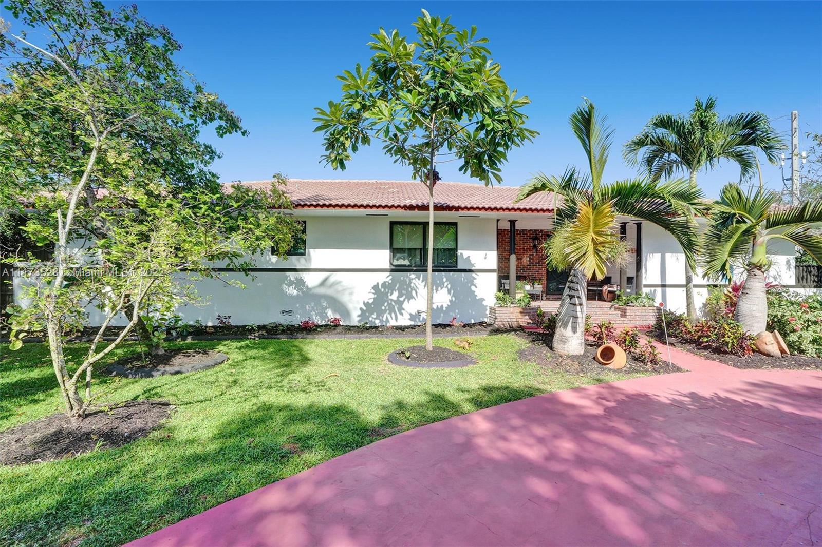 10801 Griffing Boulevard Biscayne Park, FL 33161 - Photo 72 of 77 a view of a backyard with a sitting area and slide