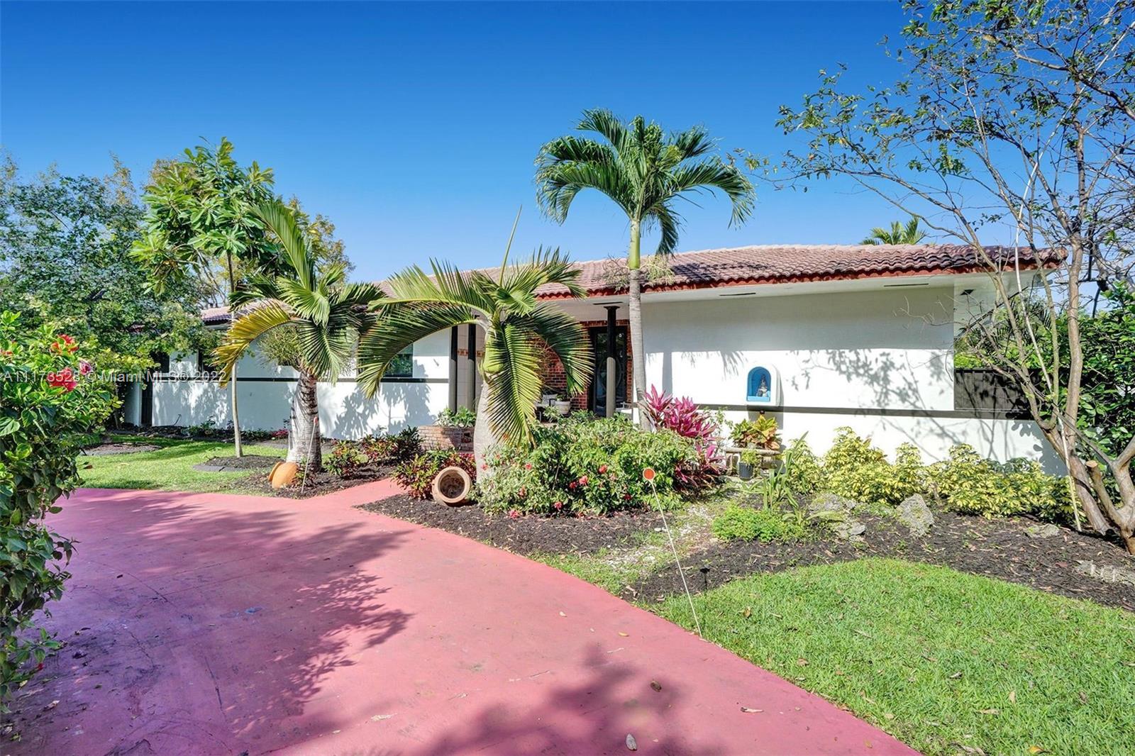 10801 Griffing Boulevard Biscayne Park, FL 33161 - Photo 73 of 77 a front view of a house with garden